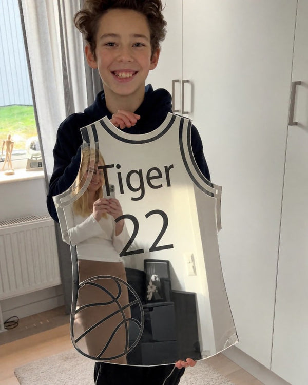 Photo from Camille R.'s review: a boy holding his basketball jersey mirror