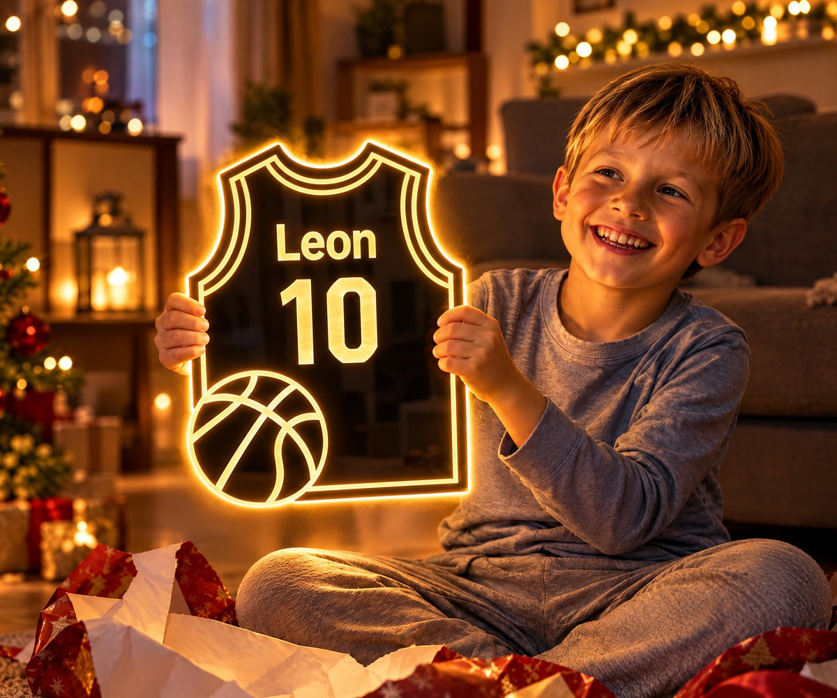 A boy unwraps his glowing HOOPLUME basketball jersey mirror with his name and jersey number on Christmas morning